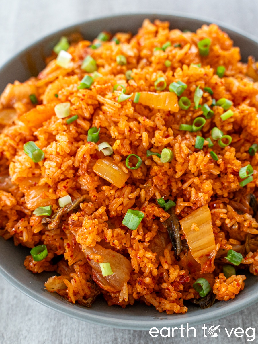 A bowl full of kimchi-bokkeumbap is set out on a grey countertop.
