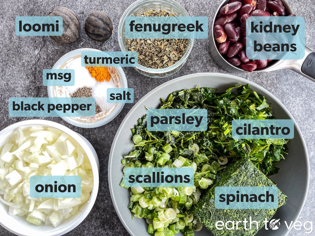 Ingredients, herbs, and spices for vegetarian ghormeh sabzi on a grey counter.