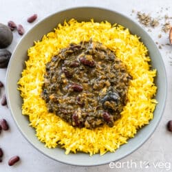 A large bowl of yellow basmati rice with ghormeh sabzi in the centre.