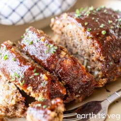 Impossible Meatloaf slices on a golden baking pan.