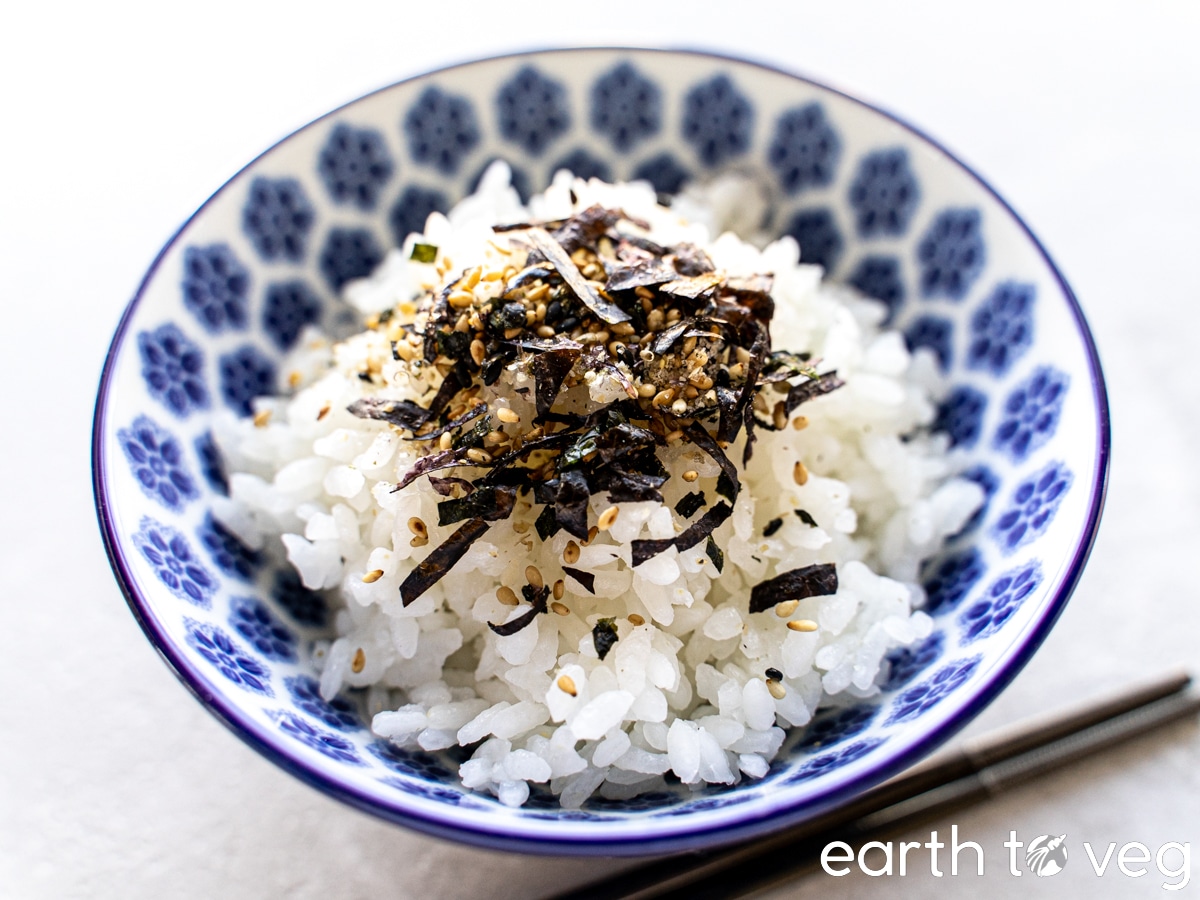 Nori komi furikake is sprinkled over a small bowl of white rice.