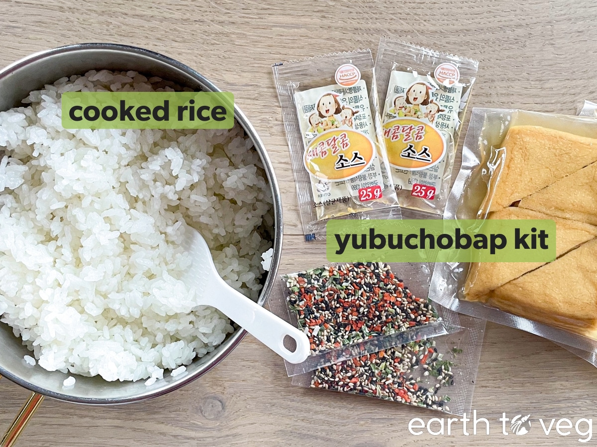 A bowl of cooked white rice next to a yubuchobap kit.