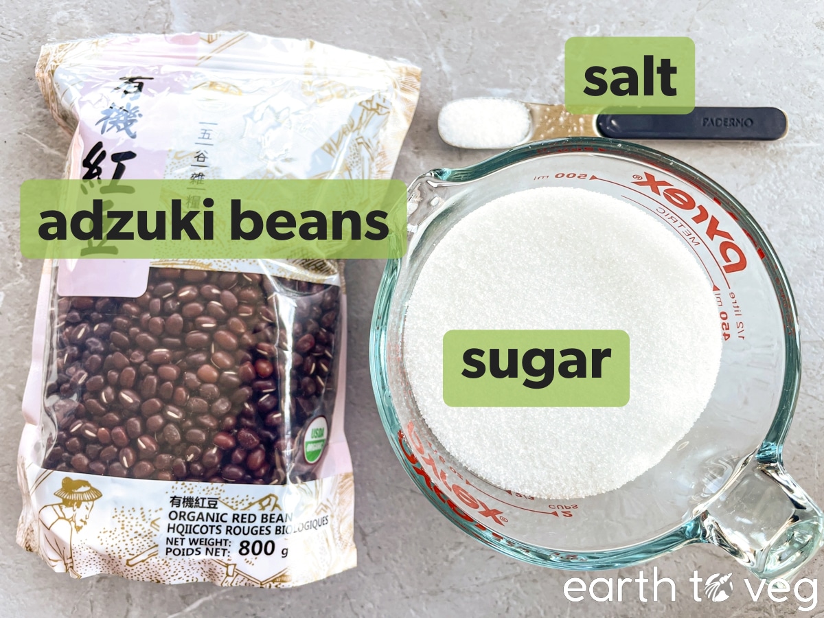 Adzuki beans, sugar, and salt on a grey countertop.