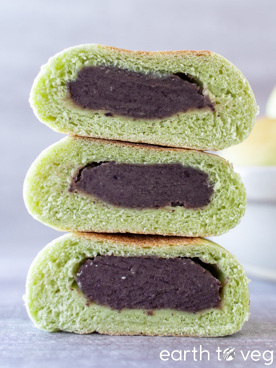 Cross section of three pandan red bean buns stacked on top of each other.