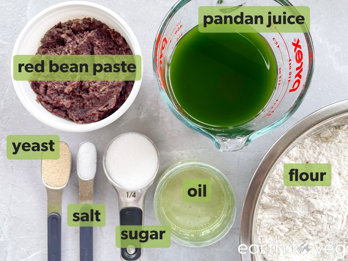 Raw ingredients for pandan red bean buns on a grey countertop.