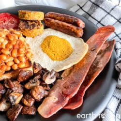 Hearty vegan fry up served on a massive plate.