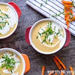 Small bowls of vegetable marrow soup on a wooden table.