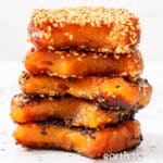 A stack of Chinese pumpkin rice cakes coated with sesame seeds.