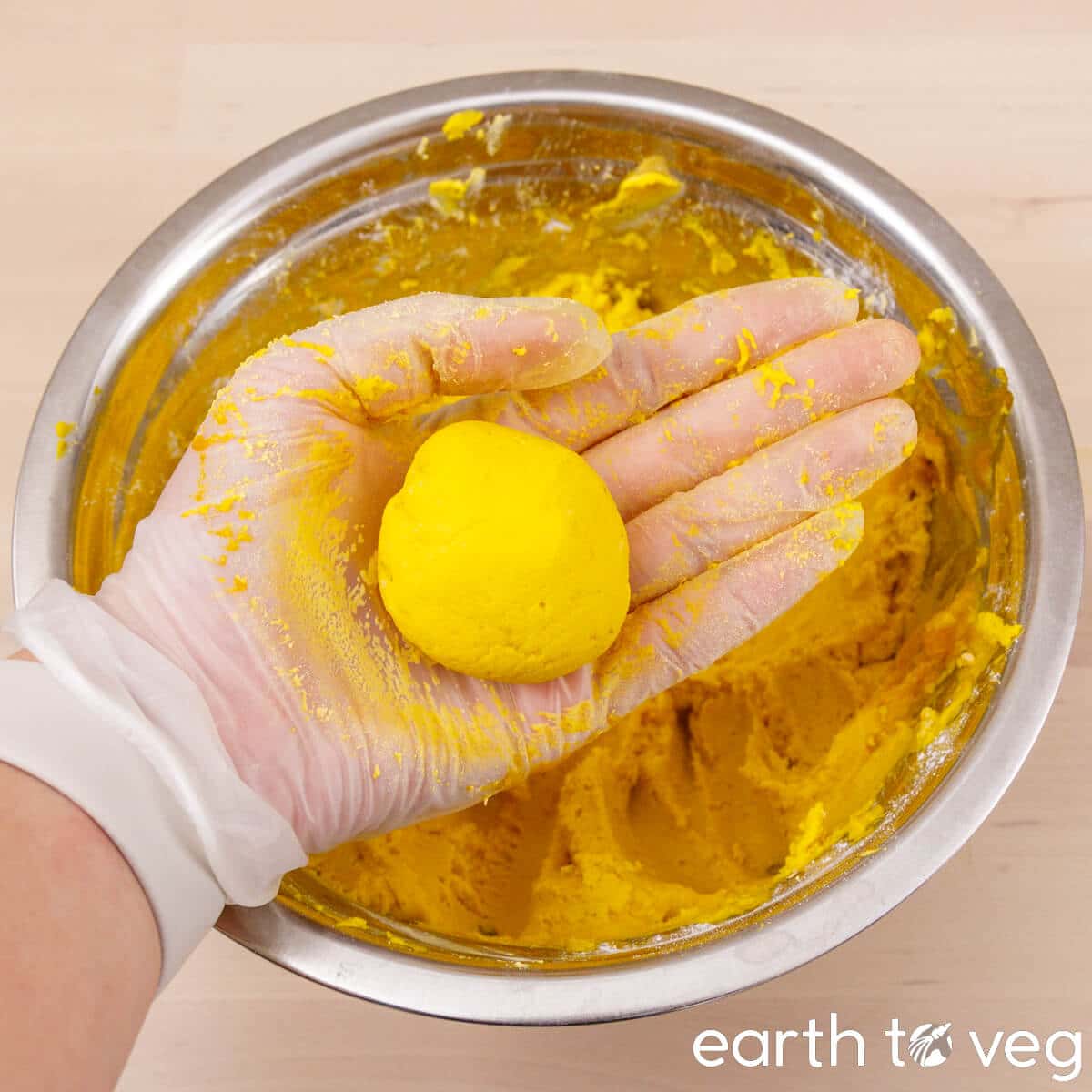 The pumpkin rice cake dough is rolled into small balls.