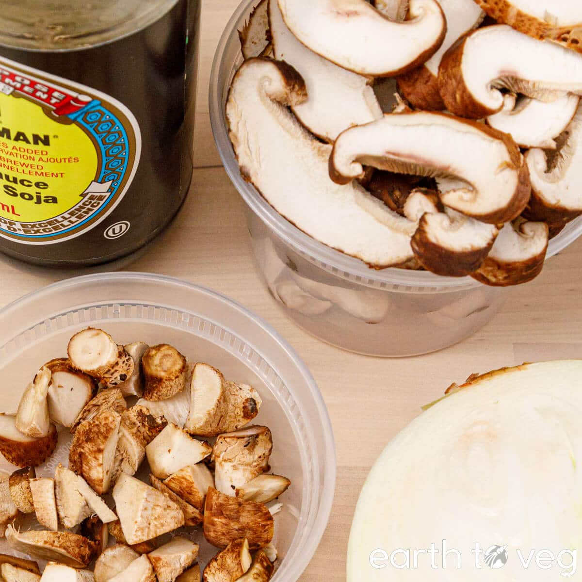 Sliced shiitake mushroom caps and stems in separate containers.