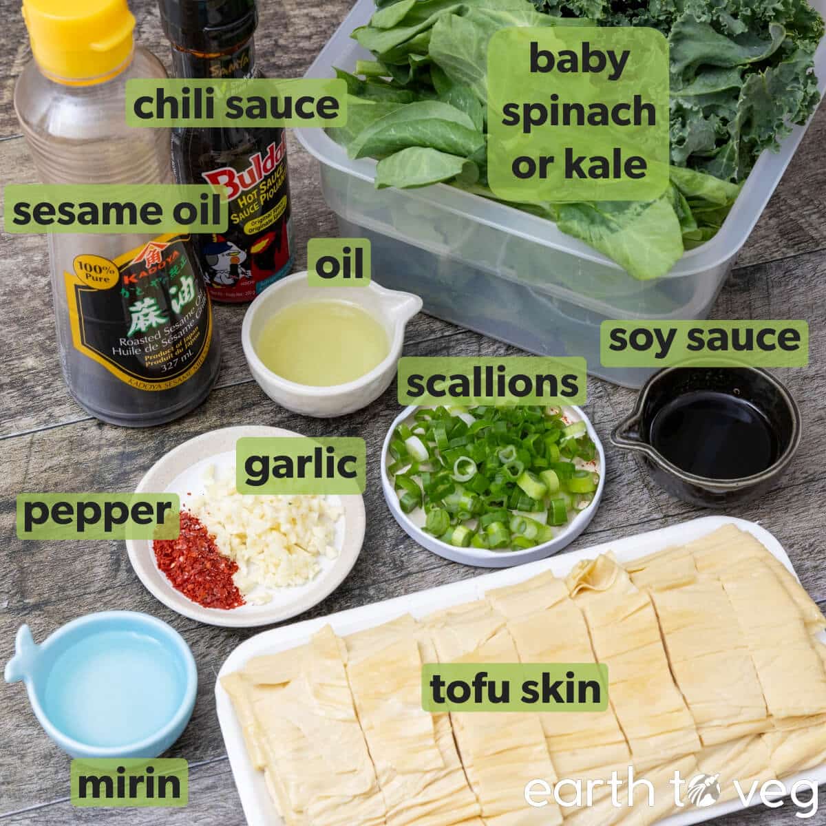 Ingredients for the tofu skin stir fry on a dark wood table.
