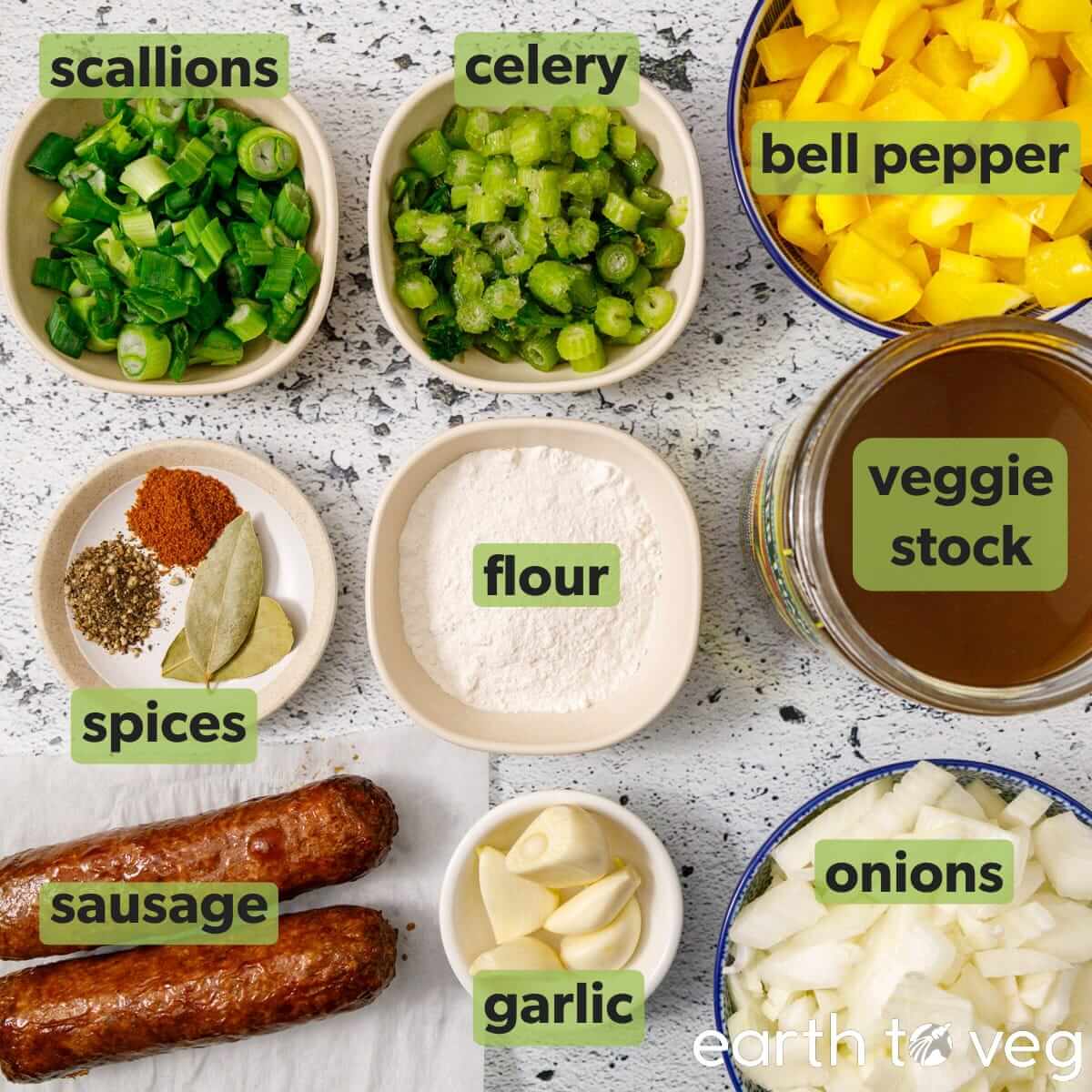 Ingredients for vegan gumbo are laid out on a white cooking counter.