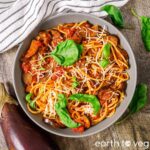 Vegan spaghetti alla norma in a large pasta bowl.