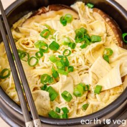 Tofu skin yuba soup with garnished with scallions.