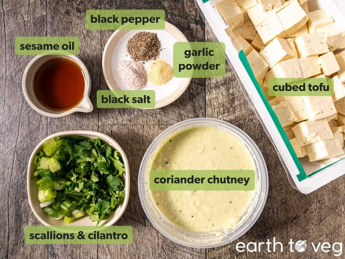 Ingredients for chutney tofu scramble on a wooden countertop.