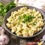 A big palte of cilantro chutney tofu scramble topped with fresh herbs.