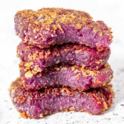 A stack of purple sweet potato pan-fried mochi cakes.