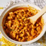 Vegan cheeseburger pasta stirred with a wooden spoon.